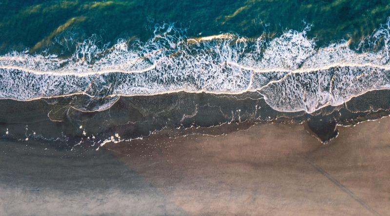 Waves Crashing On Beach From Above